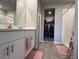 Modern bathroom featuring a vanity with storage, a walk-in closet and a large walk-in shower at 1249 Oak Valley Dr, Auburndale, FL 33823