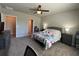 A comfortable bedroom boasts plush carpeting, neutral walls, and an ensuite bathroom for added convenience at 1249 Oak Valley Dr, Auburndale, FL 33823