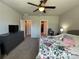 Bright bedroom features a ceiling fan, neutral walls, and easy access to the walk-in closet and Primary bath at 1249 Oak Valley Dr, Auburndale, FL 33823