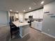 Modern kitchen with white cabinets, quartz countertops, stainless steel appliances, and a center island at 1249 Oak Valley Dr, Auburndale, FL 33823