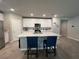 Modern kitchen showcasing a large island, stainless steel appliances, and abundant storage within sleek white cabinets at 1249 Oak Valley Dr, Auburndale, FL 33823