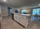 Living room showcasing an open floor plan with seamless flow from the kitchen island, creating a welcoming space at 1249 Oak Valley Dr, Auburndale, FL 33823