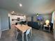 Open-concept living room featuring modern furnishings, a dining table, and seamless flow into the kitchen area at 1249 Oak Valley Dr, Auburndale, FL 33823