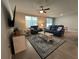 Bright living room with stylish furniture, a large rug, and sliding doors leading to the backyard at 1249 Oak Valley Dr, Auburndale, FL 33823