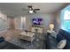 Inviting living room with tile floors, contemporary furniture, and a mounted TV for entertainment at 1249 Oak Valley Dr, Auburndale, FL 33823