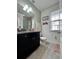 Bathroom featuring a granite countertop, dark wood vanity, and modern fixtures at 14049 Millington St, Orlando, FL 32832