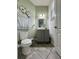 Half bathroom with a decorative mirror and floral artwork on the walls at 14049 Millington St, Orlando, FL 32832