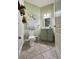 Half bathroom with a decorative mirror and floral artwork on the walls at 14049 Millington St, Orlando, FL 32832