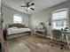Cozy bedroom with daybed, vanity, desk, and wood laminate flooring at 14049 Millington St, Orlando, FL 32832