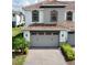 Two-story home featuring an attached two-car garage and a red-tiled roof at 14049 Millington St, Orlando, FL 32832
