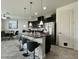 Modern kitchen featuring granite countertops, stainless steel appliances, and an island with bar seating at 14049 Millington St, Orlando, FL 32832