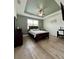 A primary bedroom featuring an accent ceiling, a ceiling fan, and a large bed at 14049 Millington St, Orlando, FL 32832