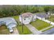 Aerial view of a home with solar panels, a front yard, and a two car garage at 147 Pompei Dr, Kissimmee, FL 34758