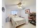 Bright bedroom with tile floors, ceiling fan, and simple decor at 147 Pompei Dr, Kissimmee, FL 34758