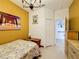 Cozy bedroom features bright yellow walls, a floral bedspread, and lots of natural light at 147 Pompei Dr, Kissimmee, FL 34758