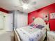 Bedroom with a red accent wall, closet, and view of the doorway at 147 Pompei Dr, Kissimmee, FL 34758