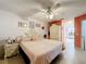 Comfortable bedroom features pink bedding, vintage furniture, and a ceiling fan at 147 Pompei Dr, Kissimmee, FL 34758