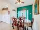 Elegant dining room featuring a dark wood table and turquoise accent wall at 147 Pompei Dr, Kissimmee, FL 34758