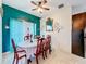 Formal dining room with a dark wood table and turquoise accent wall at 147 Pompei Dr, Kissimmee, FL 34758