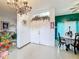 Bright entryway with a decorative chandelier, floral accents, and tiled floors at 147 Pompei Dr, Kissimmee, FL 34758
