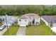 A two-story home with solar panels, a front lawn, and a two car garage at 147 Pompei Dr, Kissimmee, FL 34758