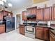 Kitchen with stainless steel appliances, dark cabinets, and granite countertops at 147 Pompei Dr, Kissimmee, FL 34758