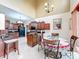Open kitchen with dark cabinets, granite countertops, island, and breakfast nook at 147 Pompei Dr, Kissimmee, FL 34758