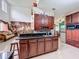 Kitchen featuring dark wood cabinets, an island with breakfast bar, and tiled floors at 147 Pompei Dr, Kissimmee, FL 34758