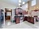 Spacious kitchen featuring dark wood cabinets, stainless steel appliances, and tiled floors at 147 Pompei Dr, Kissimmee, FL 34758