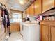 Laundry room with washer, dryer, wooden cabinets and counters at 147 Pompei Dr, Kissimmee, FL 34758