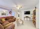 Cozy living area features a ceiling fan, neutral tones, and ceramic tile flooring at 147 Pompei Dr, Kissimmee, FL 34758