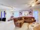 Living space featuring ceramic tile flooring, a ceiling fan, and a comfortable sectional couch at 147 Pompei Dr, Kissimmee, FL 34758
