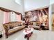 Elegant living room featuring high ceilings, ornate sofas, and decorative wallpaper at 147 Pompei Dr, Kissimmee, FL 34758