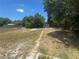 Expansive backyard area with a shed offering outdoor storage solutions and clear, sunny skies at 1539 Roselawn Sw St, Winter Haven, FL 33880