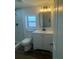 Modern bathroom featuring a sleek vanity, updated fixtures, and tiled shower with glass door at 1539 Roselawn Sw St, Winter Haven, FL 33880