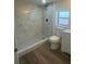 Modern bathroom featuring a glass shower with sleek fixtures and neutral toned marble-style tiling at 1539 Roselawn Sw St, Winter Haven, FL 33880