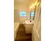 Well-lit bathroom showcasing a modern vanity with mirror and efficient toilet fixtures at 1539 Roselawn Sw St, Winter Haven, FL 33880
