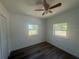 Bright bedroom with new floors, two windows offering natural light, and a closet at 1539 Roselawn Sw St, Winter Haven, FL 33880