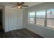 Bright bedroom with natural light, closet, and contemporary ceiling fan at 1539 Roselawn Sw St, Winter Haven, FL 33880