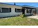 Charming single-story home featuring a well-kept lawn, black shutters, and a welcoming entryway at 1539 Roselawn Sw St, Winter Haven, FL 33880