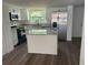 Contemporary kitchen with stainless steel appliances, granite counters, and a central island at 1539 Roselawn Sw St, Winter Haven, FL 33880