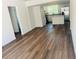 Spacious living room showing updated floors, flowing into a bright and airy modern kitchen at 1539 Roselawn Sw St, Winter Haven, FL 33880