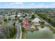 Aerial view of charming lakeside townhomes, featuring lush landscaping and serene water views at 2200 San Vittorino Cir # 105, Kissimmee, FL 34741