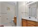 Bathroom showcasing a wood vanity, toilet, towel rack, and large mirror at 2200 San Vittorino Cir # 105, Kissimmee, FL 34741