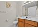 Bathroom featuring a toilet, vanity and mirror with modern lighting at 2200 San Vittorino Cir # 105, Kissimmee, FL 34741