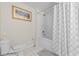 Bathroom with shower-tub combo and toilet, as well as a painting on the wall at 2200 San Vittorino Cir # 105, Kissimmee, FL 34741