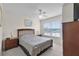 Bedroom with a fan, window, and nightstands at 2200 San Vittorino Cir # 105, Kissimmee, FL 34741