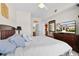 Comfortable Primary bedroom featuring a TV, ceiling fan, and an ensuite at 2200 San Vittorino Cir # 105, Kissimmee, FL 34741