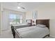 Bedroom with twin beds, ceiling fan, and a window with a neighborhood view at 2200 San Vittorino Cir # 105, Kissimmee, FL 34741