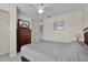 Comfortable bedroom with a ceiling fan, a large dresser with TV, and closet at 2200 San Vittorino Cir # 105, Kissimmee, FL 34741